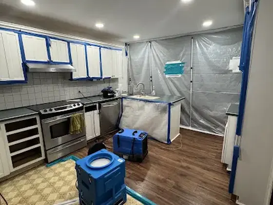 Kitchen under containment with drying equipment in a Woodstock home