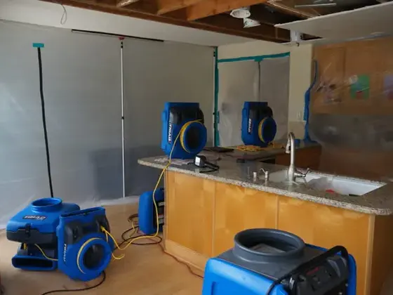 Air movers drying kitchen cabinets and flooring in Cherokee County